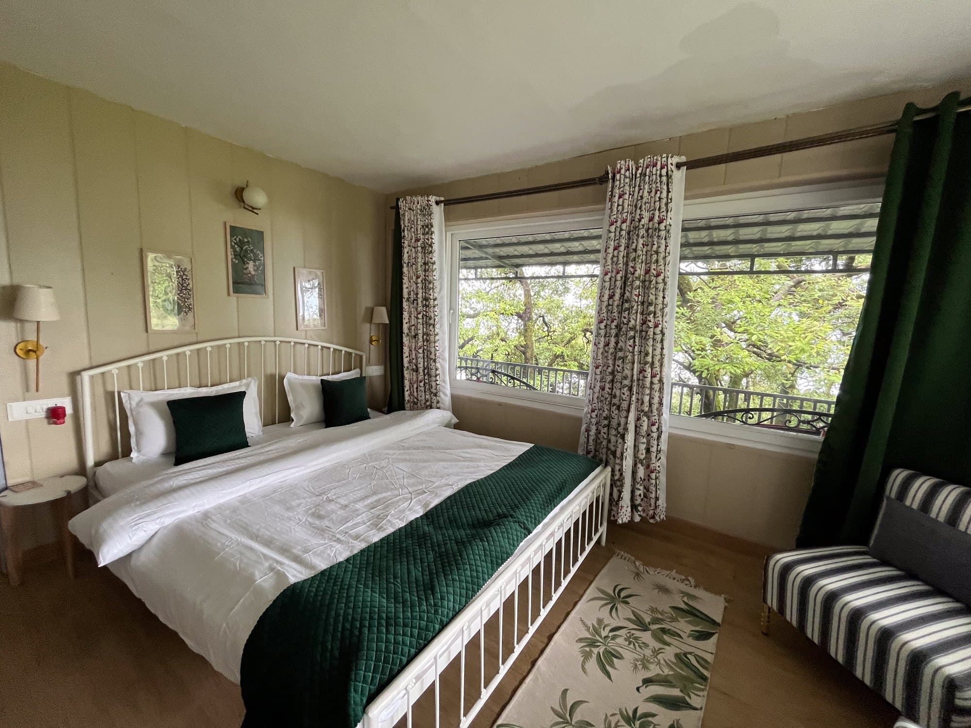 Corner windows, a green throw at Shail Shikhar Cottage, Mussoorie