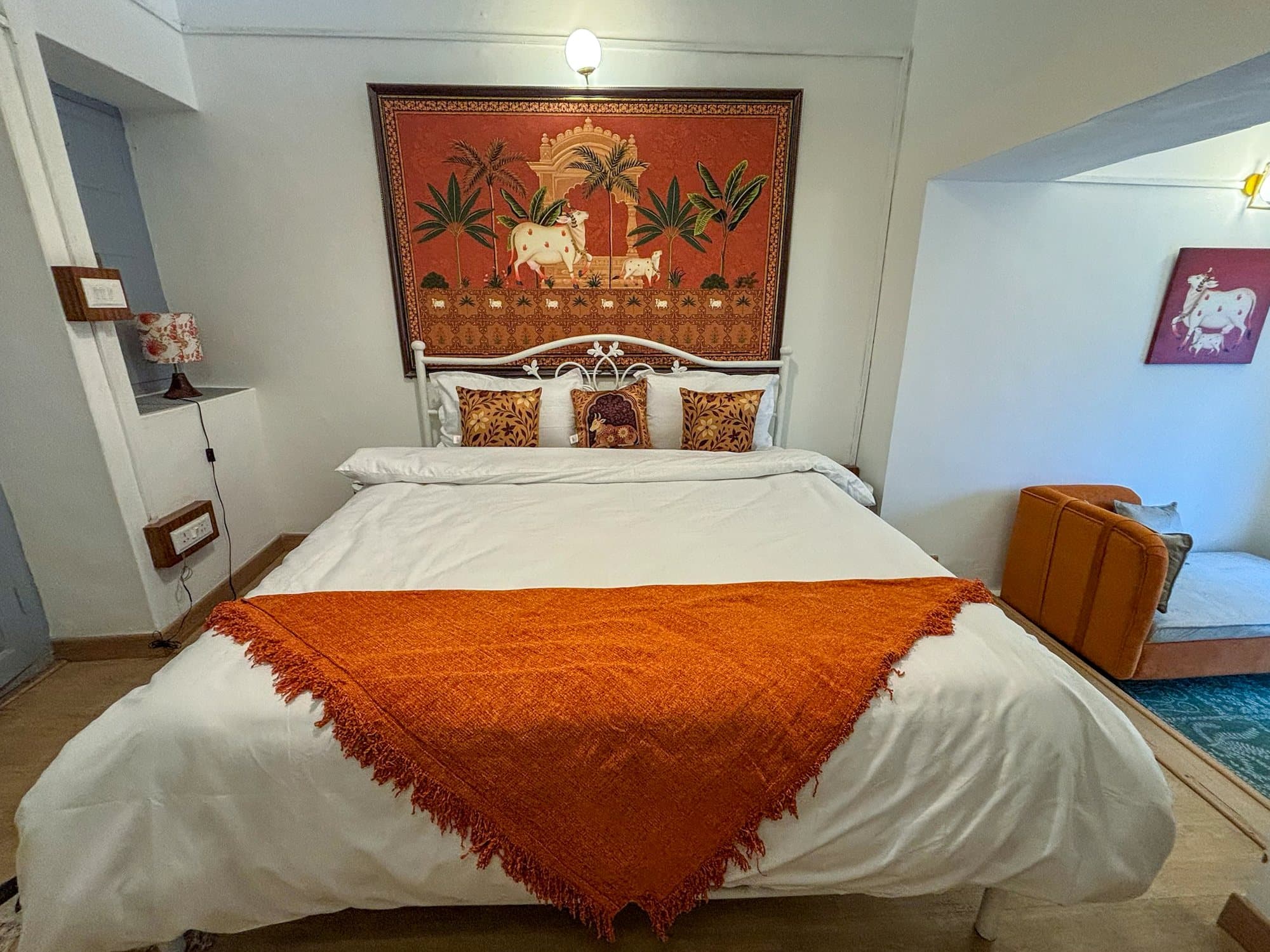The cow and her calf among palms: a Pichwai in saffron at Shail Shikhar Cottage, Mussoorie