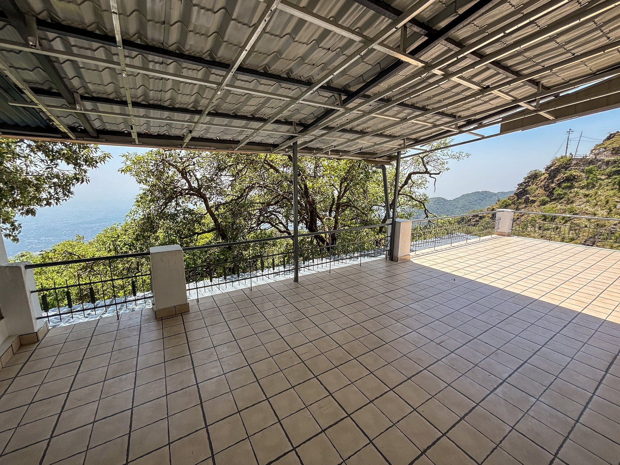The covered terrace at Shail Shikhar, tiled and open to the valley, shared by rooms 02 and 04